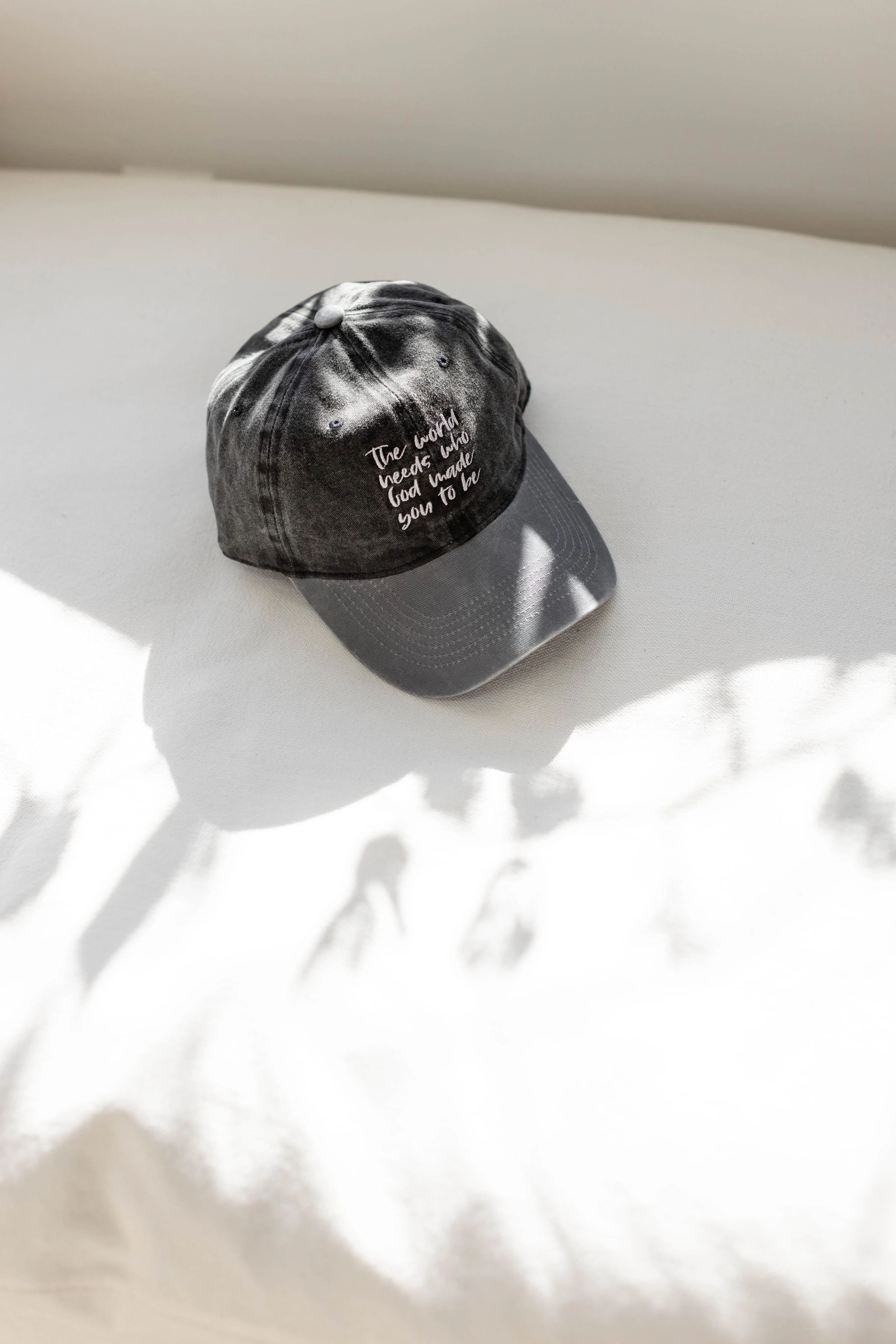 'The World Needs' Baseball Cap in Washed Black